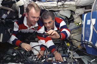 STS-89 Mission Specialists David Wolf and Andrew Thomas examine the Cocult experiment, the responsibility for which is shifted from MS Wolf to MS Thomas during his stay on the Mir Space Station. 